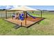Community playground with multiple slides and play structures under a shaded canopy at 4719 Bold Peacock Bnd, Bartow, FL 33830