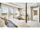 Bright bedroom with four poster bed, large windows, and a view into the hall at 5260 Stone Ridge Pl, St Cloud, FL 34771