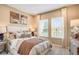 Serene bedroom offering neutral tones, two sunlit windows, and inviting furnishings at 5260 Stone Ridge Pl, St Cloud, FL 34771