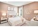 Stylish bedroom featuring a plush bed, soft pink accents, and decorative soccer ball light at 5260 Stone Ridge Pl, St Cloud, FL 34771