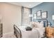 Cozy bedroom with calming blue accent wall, natural light, and stylish decor at 5260 Stone Ridge Pl, St Cloud, FL 34771