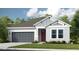 Charming single-story home featuring a two-car garage, well-maintained lawn and Craftsman-style architectural details at 5260 Stone Ridge Pl, St Cloud, FL 34771