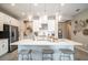 Bright and airy kitchen showcasing white cabinets, stainless steel appliances, pendant lighting and a large center island at 5260 Stone Ridge Pl, St Cloud, FL 34771