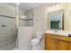 Tiled bathroom featuring an enclosed shower with glass doors, vanity, and a toilet at 725 Giant Oak Rd, Lakeland, FL 33810