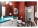 Rustic bathroom features a vibrant teal vanity top and direct access to the backyard at 725 Giant Oak Rd, Lakeland, FL 33810