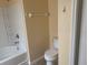 Bathroom with a tiled shower-tub combination, tile flooring and toilet near the doorway at 1555 Scarlet Oak Loop # 113A, Winter Garden, FL 34787