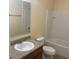 Bright bathroom featuring a tiled shower-tub combination, granite vanity and tile flooring at 1555 Scarlet Oak Loop # 113A, Winter Garden, FL 34787