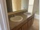 Bathroom with double vanity, granite countertop, tile flooring, and mirror reflecting the tub-shower combo at 1555 Scarlet Oak Loop # 113A, Winter Garden, FL 34787