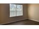 Empty bedroom featuring laminate floors, a large window and light walls at 1555 Scarlet Oak Loop # 113A, Winter Garden, FL 34787