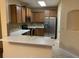 Modern kitchen featuring stainless steel appliances, quartz countertops, and wooden cabinets at 1555 Scarlet Oak Loop # 113A, Winter Garden, FL 34787