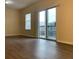 Living room area featuring wood laminate floors and natural light at 1555 Scarlet Oak Loop # 113A, Winter Garden, FL 34787