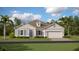 Charming single-story home featuring a symmetrical design, inviting entrance, and a well-manicured lawn and professional landscaping at 4791 Waltham Forest Dr, Davenport, FL 33837