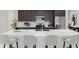 Modern kitchen featuring a large island with seating, stainless steel appliances, and stylish dark brown cabinetry and backsplash at 4791 Waltham Forest Dr, Davenport, FL 33837
