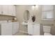 Laundry room featuring modern washer and dryer, storage cabinets, a sink, and a toilet at 5190 Goldfinch Dr, St Cloud, FL 34771