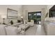 Bright living room featuring high ceilings, neutral decor, stylish furniture, and sliding glass doors to the outdoor living area at 5190 Goldfinch Dr, St Cloud, FL 34771