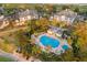 Aerial view of community pool showcasing inviting seating and beautiful landscaping at 7615 Heritage Crossing Way # 102, Reunion, FL 34747