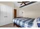 Comfortable bedroom features a queen bed with a plaid comforter, closet, and neutral colored walls at 7615 Heritage Crossing Way # 102, Reunion, FL 34747