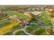 Panoramic aerial shot of lush golf course highlighting undulating greens, palm trees, and sand traps at 7615 Heritage Crossing Way # 102, Reunion, FL 34747