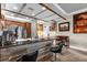 Open-concept kitchen with wooden bar, stainless steel appliances, and rustic wood details at 7615 Heritage Crossing Way # 102, Reunion, FL 34747