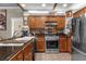 Well-equipped kitchen with stainless steel appliances and a tiled backsplash at 7615 Heritage Crossing Way # 102, Reunion, FL 34747