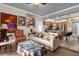 Inviting living room showcasing vintage posters and a comfortable seating arrangement at 7615 Heritage Crossing Way # 102, Reunion, FL 34747