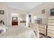 Inviting main bedroom features a dresser and ensuite bathroom with a tile shower at 7615 Heritage Crossing Way # 102, Reunion, FL 34747