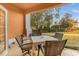 Charming outdoor patio with a table and four chairs, perfect for enjoying the serene golf course view at 7615 Heritage Crossing Way # 102, Reunion, FL 34747
