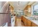 Modern kitchen featuring natural wood cabinets and access to the dining area at 848 Casselberry Dr, Lake Wales, FL 33853