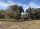 Expansive backyard with mature trees and azaleas, offering a serene and natural setting at 24605 Ne 177Th Ter, Fort Mc Coy, FL 32134