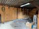 Inside a barn with exposed beams, tools, and storage, providing a functional space with a rustic aesthetic at 24605 Ne 177Th Ter, Fort Mc Coy, FL 32134