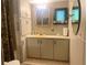 Cozy bathroom featuring cream colored cabinets and linoleum flooring at 24605 Ne 177Th Ter, Fort Mc Coy, FL 32134