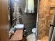 Rustic bathroom featuring wood paneling, and a tiled walk-in shower at 24605 Ne 177Th Ter, Fort Mc Coy, FL 32134