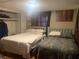 Bedroom featuring two twin beds and neutral-toned walls, well lit by a central ceiling fixture at 24605 Ne 177Th Ter, Fort Mc Coy, FL 32134
