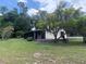 Home exterior featuring a screened-in porch and brick-lined step stones at 24605 Ne 177Th Ter, Fort Mc Coy, FL 32134