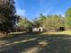 Exterior view of charming home surrounded by lush greenery and mature trees at 24605 Ne 177Th Ter, Fort Mc Coy, FL 32134