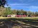 Cozy mobile home with flower-lined covered porch, set in a peaceful, spacious yard at 24605 Ne 177Th Ter, Fort Mc Coy, FL 32134