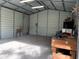 Large metal garage featuring brick flooring and functional workbench at 24605 Ne 177Th Ter, Fort Mc Coy, FL 32134