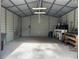 Spacious garage with brick flooring, workbench, and ample storage space at 24605 Ne 177Th Ter, Fort Mc Coy, FL 32134