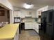 Bright kitchen with white cabinets, yellow countertops, and modern appliances, perfect for cooking at 24605 Ne 177Th Ter, Fort Mc Coy, FL 32134