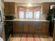 Efficient kitchen features wood cabinets, neutral countertops, updated appliances and eat in kitchen area at 24605 Ne 177Th Ter, Fort Mc Coy, FL 32134