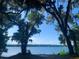 Breathtaking lake view framed by beautiful trees and Spanish moss at 24605 Ne 177Th Ter, Fort Mc Coy, FL 32134