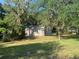 Storage outbuilding situated in the backyard with mature trees creating a beautiful backdrop at 24605 Ne 177Th Ter, Fort Mc Coy, FL 32134
