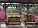 Relaxing porch with wooden swing chairs and a serene view of the well maintained, flowering yard at 24605 Ne 177Th Ter, Fort Mc Coy, FL 32134