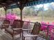 Inviting porch with rocking chairs and azaleas offering a relaxing outdoor space overlooking the natural landscape at 24605 Ne 177Th Ter, Fort Mc Coy, FL 32134