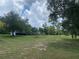 Expansive grassy property dotted with trees, presenting a serene and private setting at 24605 Ne 177Th Ter, Fort Mc Coy, FL 32134