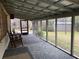 Spacious screened porch for outdoor relaxation and entertainment, with tiled floors and view of the property at 24605 Ne 177Th Ter, Fort Mc Coy, FL 32134