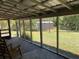 View from screened in porch that shows the lush backyard and adjacent outbuildings at 24605 Ne 177Th Ter, Fort Mc Coy, FL 32134