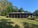 Enclosed sunroom featuring dark screens, providing a cozy and private outdoor living space at 24605 Ne 177Th Ter, Fort Mc Coy, FL 32134