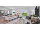 Open living room with comfortable seating, large windows, and stylish decor at 263 Puma Loop, Groveland, FL 34736