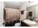 Bathroom features a granite countertop and a shower with a decorative curtain rod at 4111 Se 131St Ln, Belleview, FL 34420